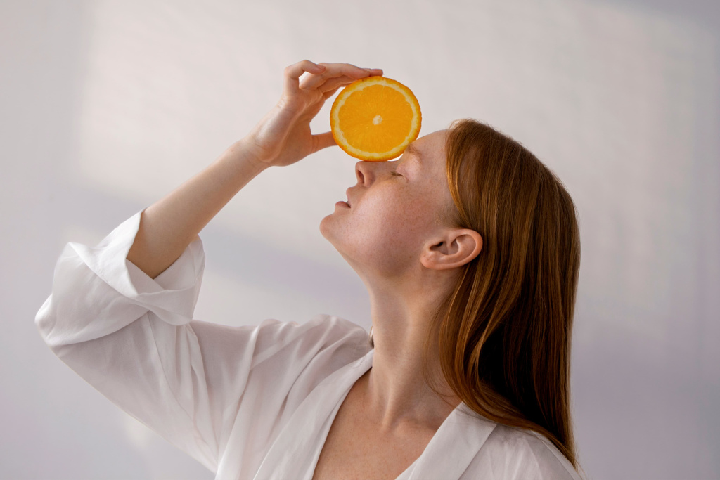 medium-shot-woman-posing-with-orange-slice (1).jpg